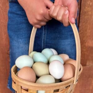 girl holds easter basket with fresh eggs